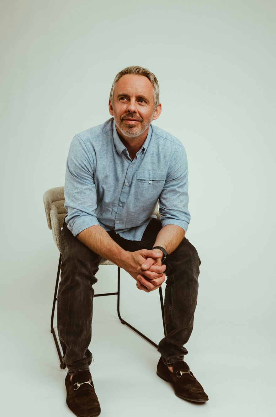 Reid Robison, MD, sitting and smiling
